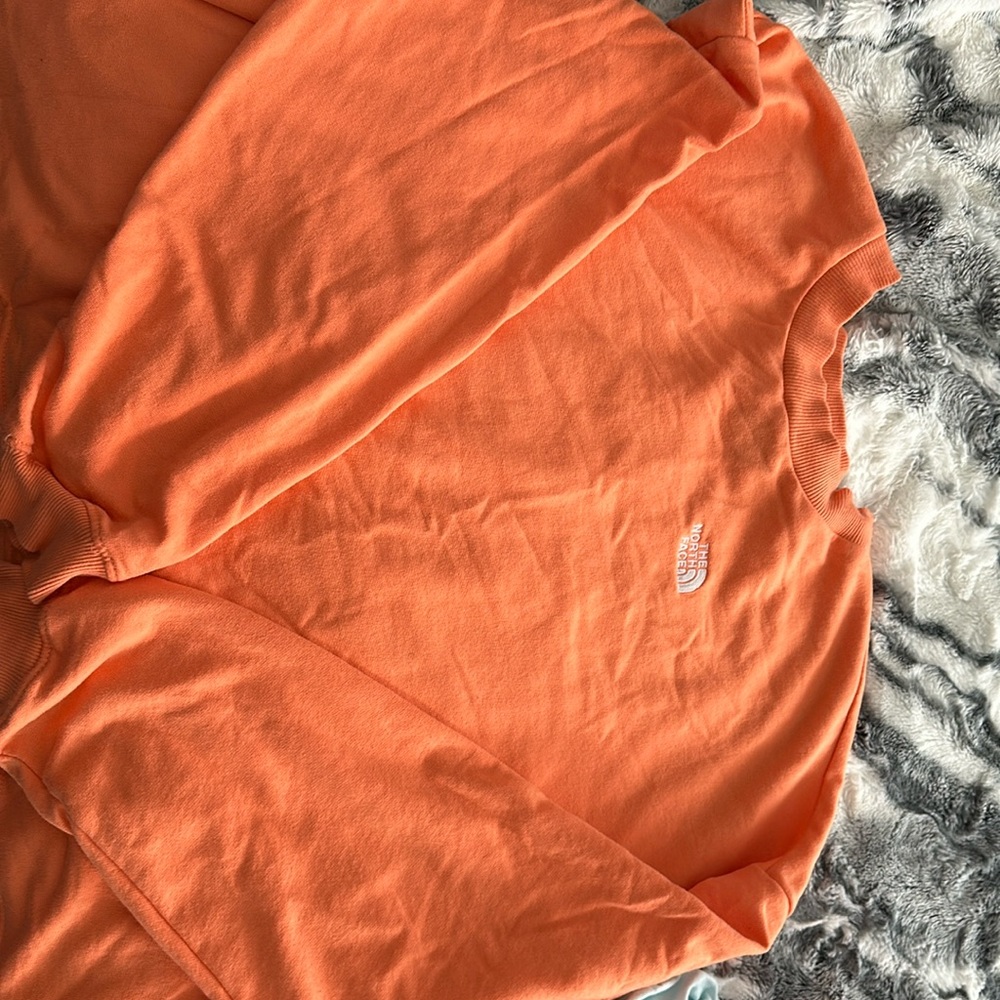 orange north face light sweater